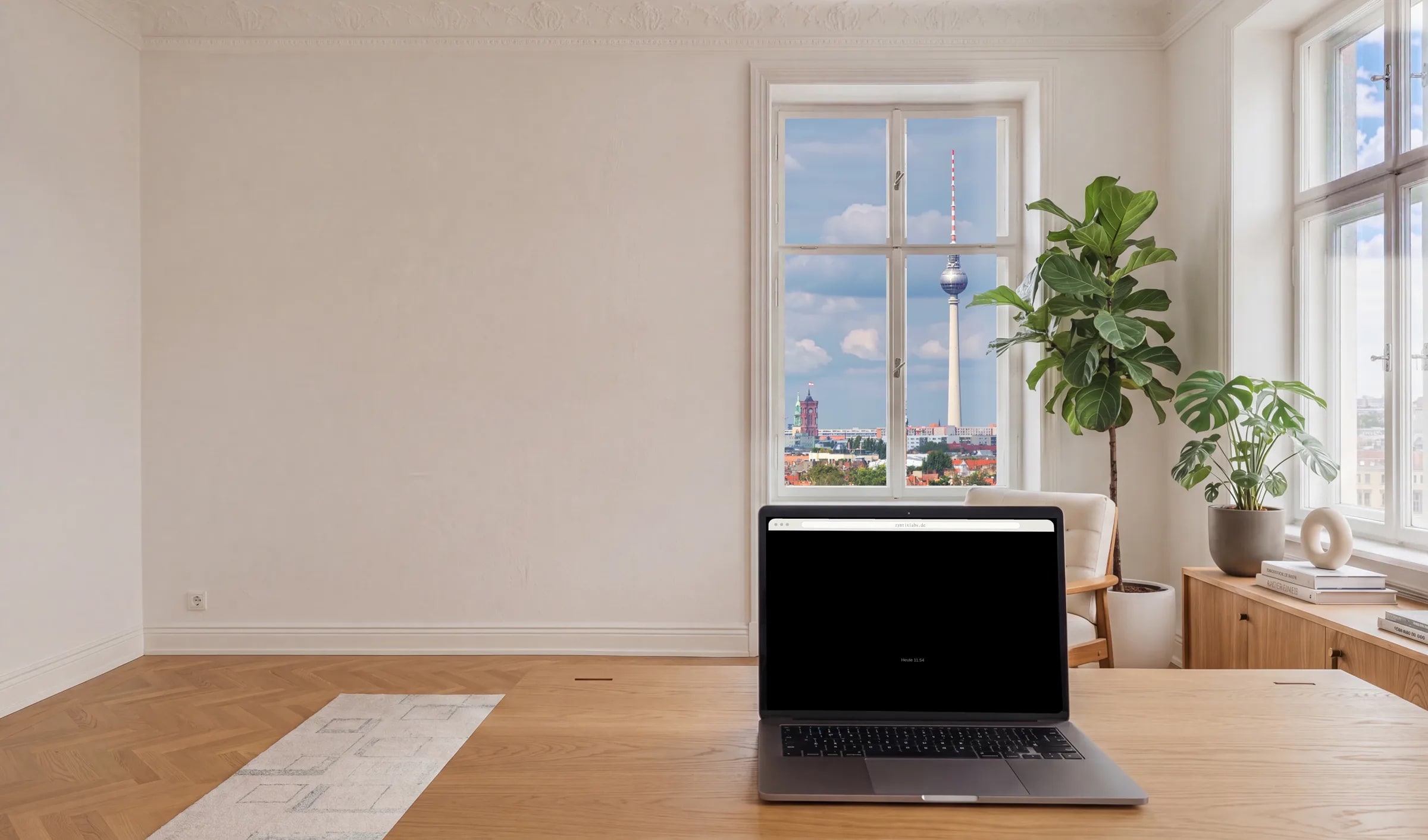 Berliner Altbau-Studio mit Blick über Berlin Mitte (Fernsehturm); auf dem MacBook läuft die Vorschau eines Web-Auftritts